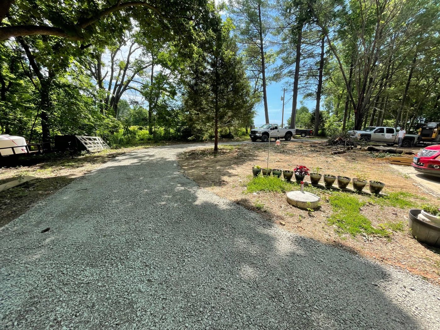 Tree-lined gravel driveway installed by Brohez Trucking LLC in Central Illinois